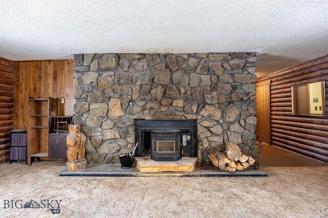 77 First Rd, Whitehall, MT 59759 - detailed view of a wood stove, carpet flooring, a textured ceiling, and log walls