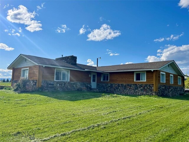77 First Rd, Whitehall, MT 59759 - rear view of property with stone siding and a lawn