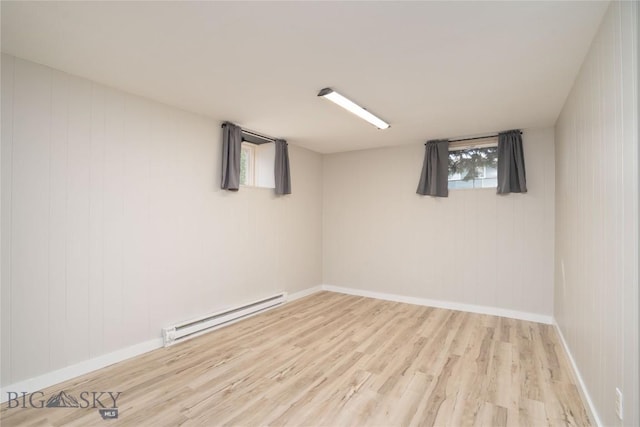 413 S Oak St, Townsend, MT 59752 - below grade area featuring baseboard heating, wood finished floors, and baseboards