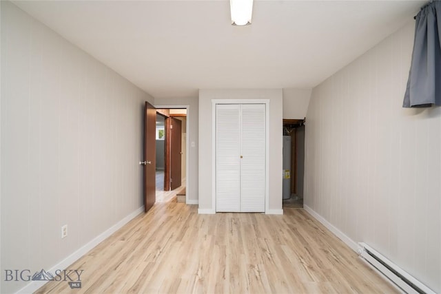 413 S Oak St, Townsend, MT 59752 - unfurnished bedroom with a baseboard radiator, light wood finished floors, a closet, and baseboards