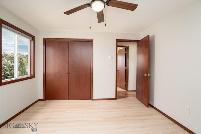 413 S Oak St, Townsend, MT 59752 - unfurnished bedroom featuring light wood-style flooring, baseboards, a closet, and ceiling fan