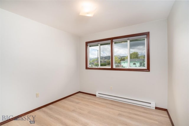 413 S Oak St, Townsend, MT 59752 - spare room with a baseboard radiator, light wood-style floors, and baseboards