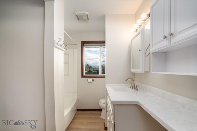 413 S Oak St, Townsend, MT 59752 - full bath with vanity, toilet, wood finished floors, baseboards, and shower / washtub combination