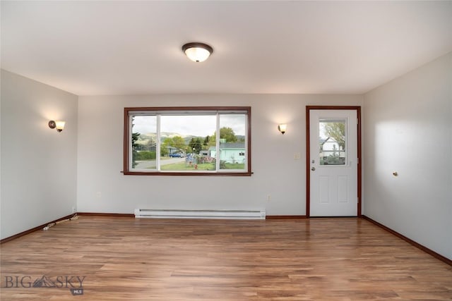 413 S Oak St, Townsend, MT 59752 - entrance foyer with baseboard heating, light wood-style flooring, and baseboards