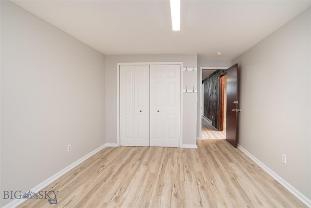 413 S Oak St, Townsend, MT 59752 - unfurnished bedroom with light wood-style floors, baseboards, and a closet