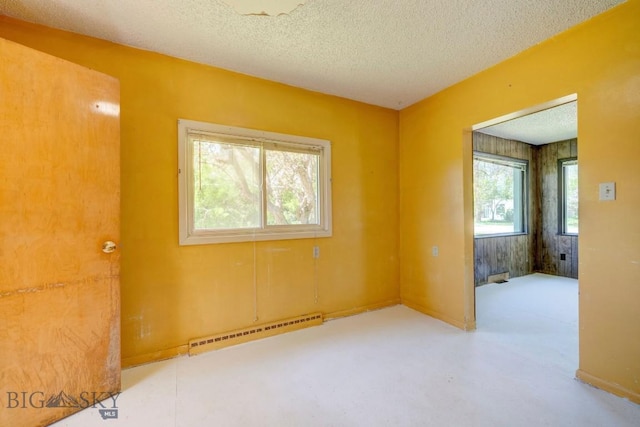 109 N Broadway, Manhattan, MT 59741 - spare room with a baseboard radiator and a textured ceiling