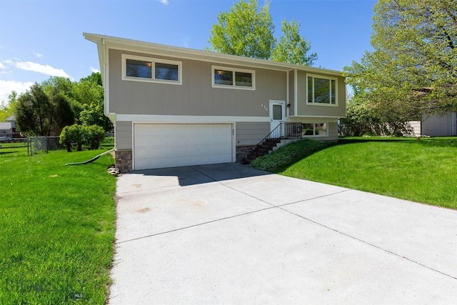 416 Morrow St, Bozeman, MT 59715 - raised ranch with a garage, concrete driveway, and stone siding