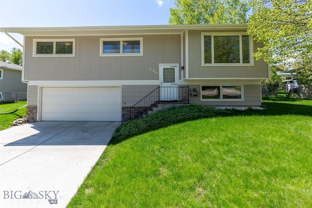 416 Morrow St, Bozeman, MT 59715 - raised ranch featuring a garage, stone siding, a front yard, and concrete driveway
