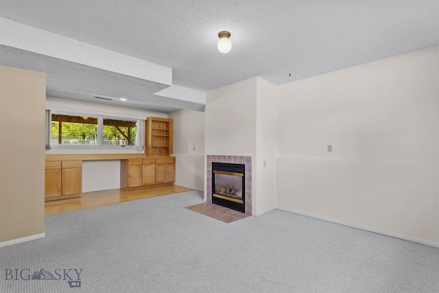 416 Morrow St, Bozeman, MT 59715 - unfurnished living room featuring light colored carpet, a fireplace, a textured ceiling, and baseboards