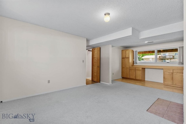 416 Morrow St, Bozeman, MT 59715 - unfurnished living room with light carpet and a textured ceiling
