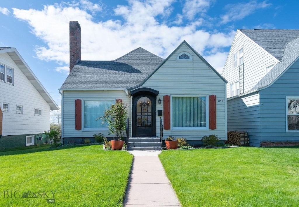 1150 W Steele St, Butte, MT 59701 - view of front of house with a front yard, a chimney, and a shingled roof