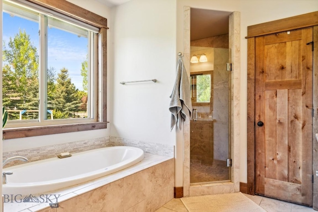 2296 Boylan Rd, Bozeman, MT 59715 - full bathroom with healthy amount of natural light, a bath, a stall shower, and tile patterned floors