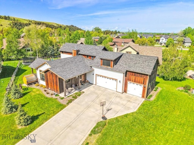 2296 Boylan Rd, Bozeman, MT 59715 - view of front of home with a shingled roof, a front yard, driveway, and board and batten siding