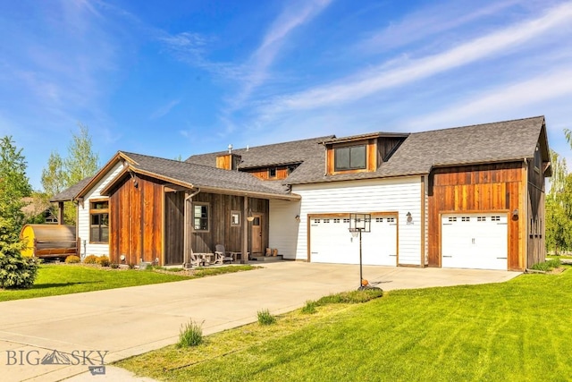 2296 Boylan Rd, Bozeman, MT 59715 - view of front of property with concrete driveway, a front lawn, an attached garage, and board and batten siding