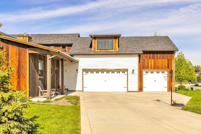 2296 Boylan Rd, Bozeman, MT 59715 - view of front facade featuring a garage, a front yard, roof with shingles, and concrete driveway