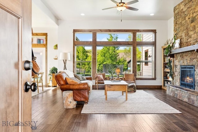 2296 Boylan Rd, Bozeman, MT 59715 - living room with a stone fireplace, ceiling fan, hardwood / wood-style floors, recessed lighting, and baseboards