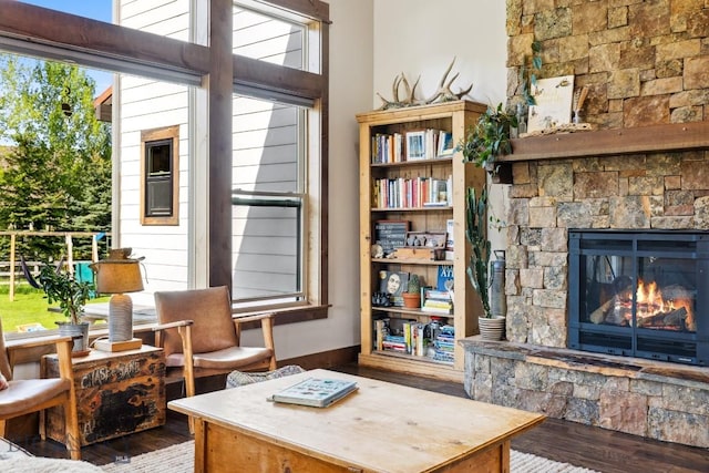 2296 Boylan Rd, Bozeman, MT 59715 - sitting room featuring wood finished floors and a stone fireplace