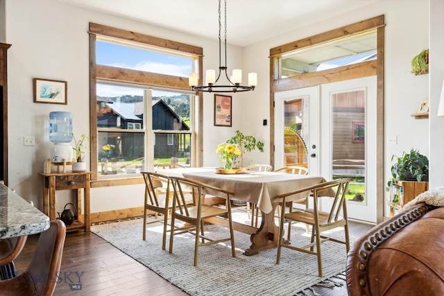 2296 Boylan Rd, Bozeman, MT 59715 - dining area with a chandelier, french doors, dark wood finished floors, and baseboards