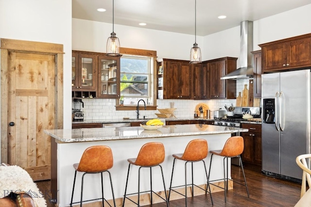 2296 Boylan Rd, Bozeman, MT 59715 - kitchen featuring stainless steel fridge with ice dispenser, wall chimney range hood, a center island, backsplash, and recessed lighting