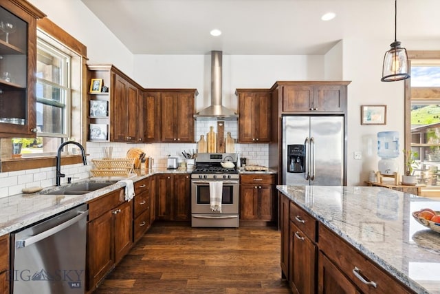 2296 Boylan Rd, Bozeman, MT 59715 - kitchen featuring stainless steel appliances, wall chimney exhaust hood, a sink, dark wood-style floors, and light stone countertops