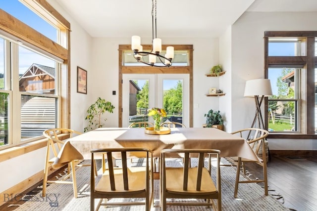 2296 Boylan Rd, Bozeman, MT 59715 - dining space featuring a chandelier, plenty of natural light, wood-type flooring, and baseboards