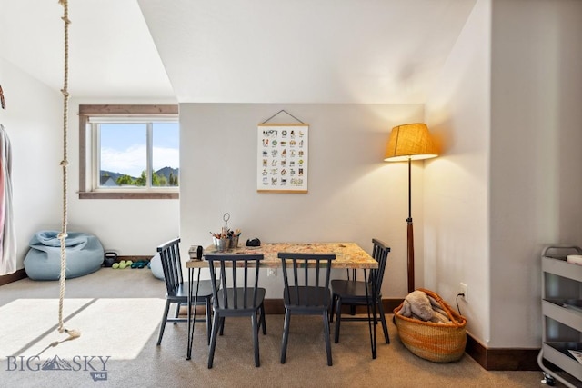 2296 Boylan Rd, Bozeman, MT 59715 - dining room with carpet floors, baseboards, and lofted ceiling