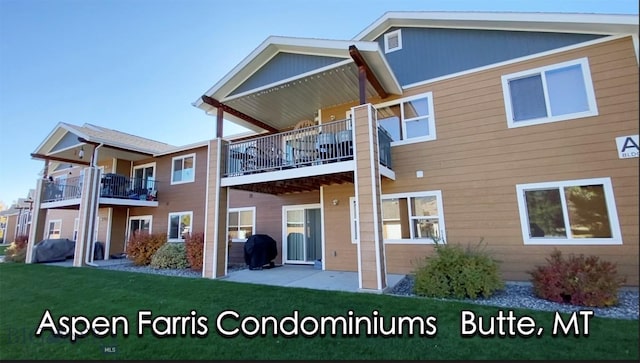 3141 Wynne Unit C2, Butte, MT 59701 - rear view of house with a balcony, a yard, and a patio