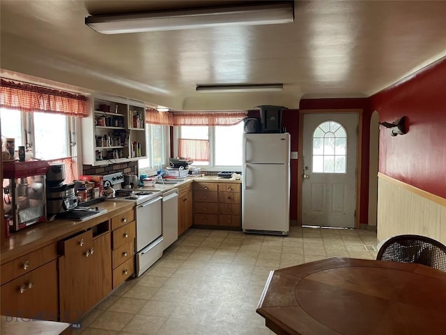 775 N Montana, Dillon, MT 59725 - kitchen with white appliances, light flooring, a sink, and open shelves
