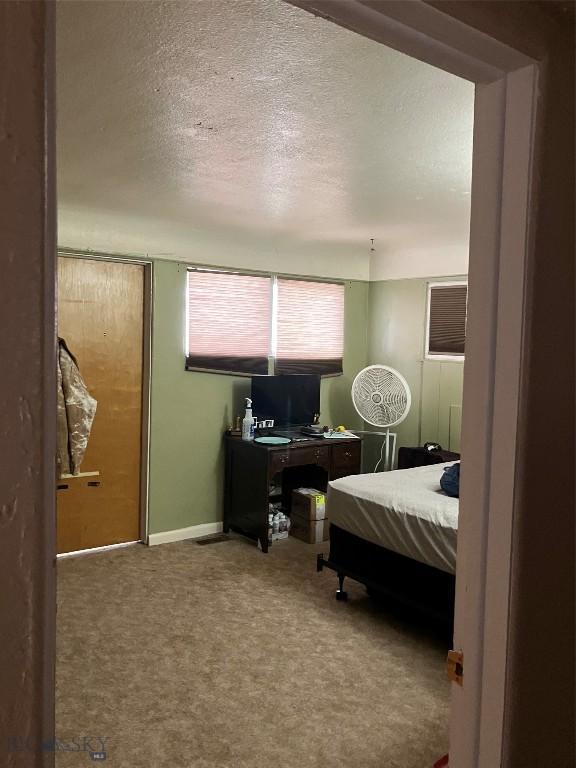 775 N Montana, Dillon, MT 59725 - carpeted bedroom with a textured ceiling