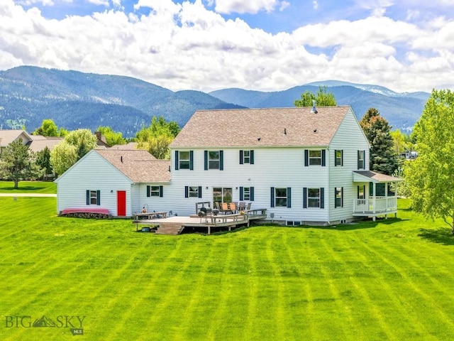 193 Lucille Ln, Bozeman, MT 59718 - rear view of property with a deck with mountain view, a lawn, and roof with shingles