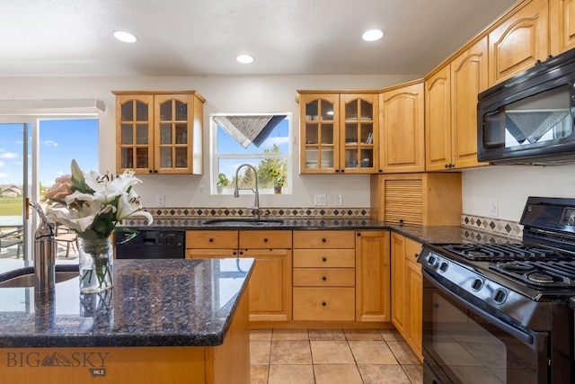 193 Lucille Ln, Bozeman, MT 59718 - kitchen with black appliances, a sink, dark stone countertops, glass insert cabinets, and recessed lighting