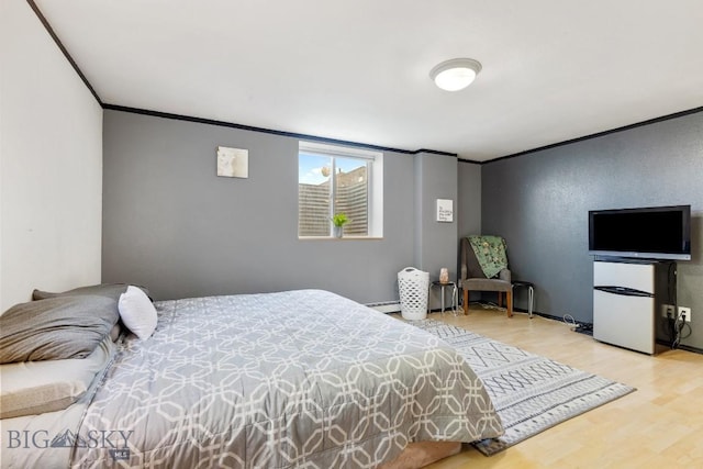 193 Lucille Ln, Bozeman, MT 59718 - bedroom with crown molding, wood finished floors, fridge, and baseboard heating
