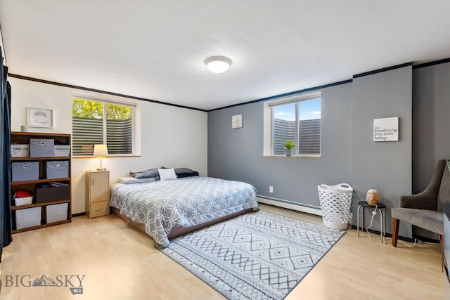 193 Lucille Ln, Bozeman, MT 59718 - bedroom featuring wood finished floors, ornamental molding, baseboard heating, and baseboards