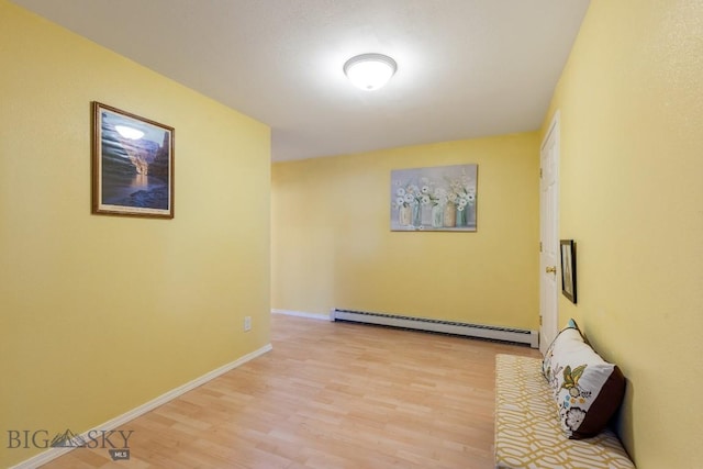 193 Lucille Ln, Bozeman, MT 59718 - corridor with a baseboard heating unit, light wood finished floors, and baseboards