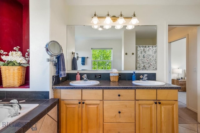 193 Lucille Ln, Bozeman, MT 59718 - full bathroom featuring double vanity, a relaxing tiled tub, and tile patterned floors