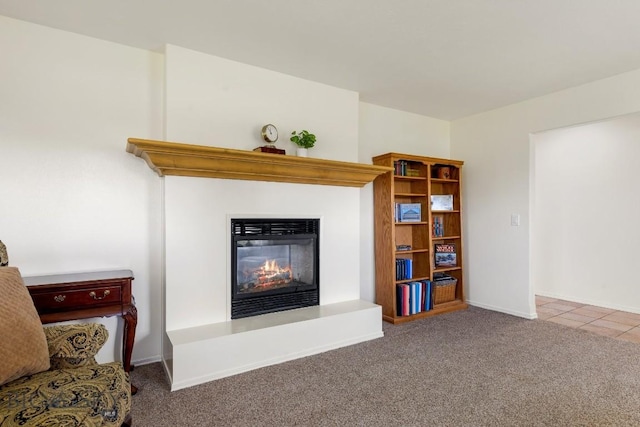 193 Lucille Ln, Bozeman, MT 59718 - tiled living area with a glass covered fireplace, carpet floors, and baseboards