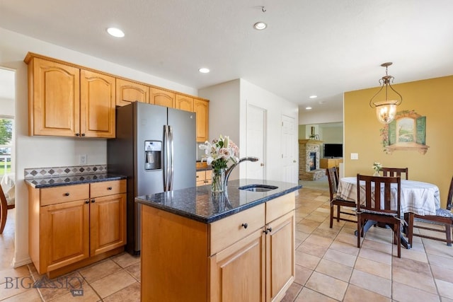 193 Lucille Ln, Bozeman, MT 59718 - kitchen with a sink, dark stone counters, a kitchen island, decorative light fixtures, and recessed lighting