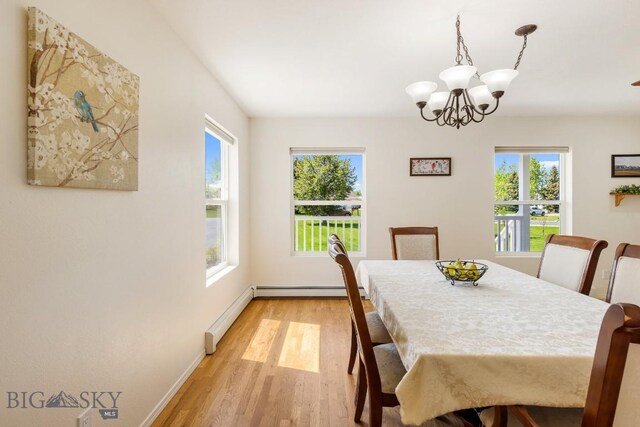 193 Lucille Ln, Bozeman, MT 59718 - dining room featuring a chandelier, light wood-style flooring, baseboards, and baseboard heating