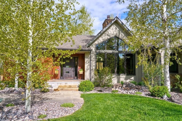 65 Triple Tree Ln, Bozeman, MT 59715 - view of front of property with a chimney and a front lawn