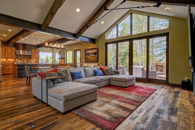 65 Triple Tree Ln, Bozeman, MT 59715 - living area with beamed ceiling, dark wood-style flooring, plenty of natural light, a chandelier, and high vaulted ceiling