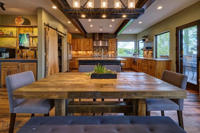 65 Triple Tree Ln, Bozeman, MT 59715 - dining area with light wood finished floors, a barn door, recessed lighting, and beamed ceiling