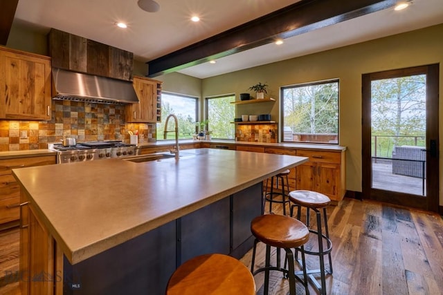 65 Triple Tree Ln, Bozeman, MT 59715 - kitchen featuring beam ceiling, a sink, wood finished floors, backsplash, and brown cabinetry