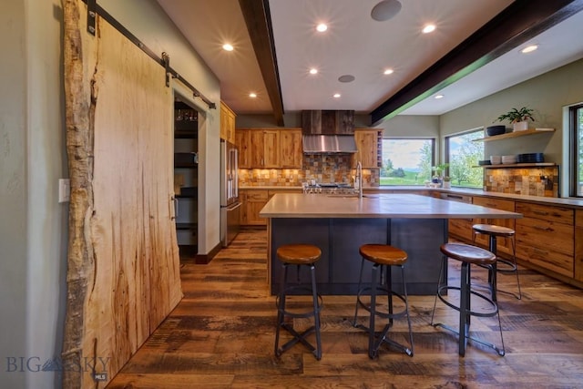 65 Triple Tree Ln, Bozeman, MT 59715 - kitchen with dark wood-style flooring, wall chimney range hood, light countertops, beamed ceiling, and tasteful backsplash
