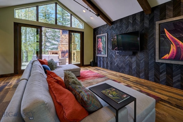 65 Triple Tree Ln, Bozeman, MT 59715 - living room with an accent wall, baseboards, and wood finished floors