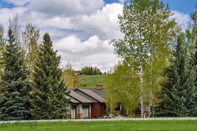 65 Triple Tree Ln, Bozeman, MT 59715 - view of front of home featuring a front yard and a chimney