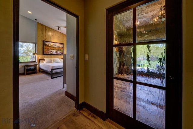 65 Triple Tree Ln, Bozeman, MT 59715 - doorway to outside with baseboards, lofted ceiling, and carpet flooring