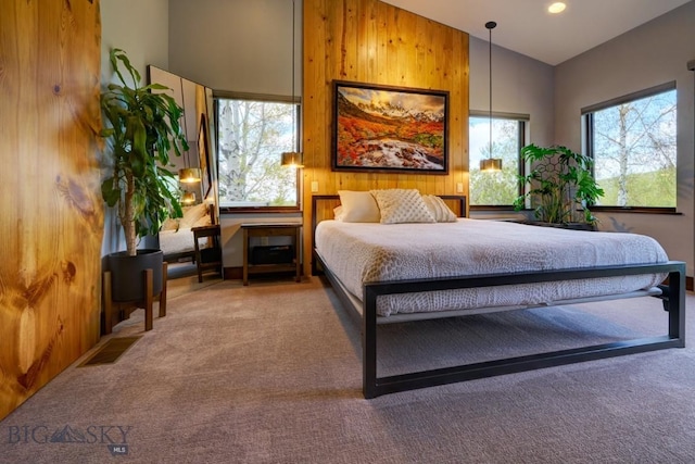 65 Triple Tree Ln, Bozeman, MT 59715 - bedroom with carpet flooring, multiple windows, wood walls, and high vaulted ceiling