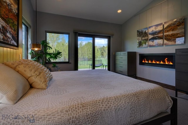 65 Triple Tree Ln, Bozeman, MT 59715 - bedroom with access to outside, a glass covered fireplace, recessed lighting, vaulted ceiling, and baseboards
