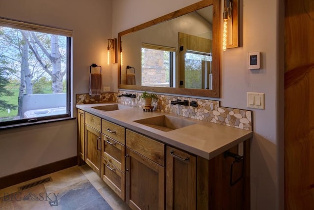 65 Triple Tree Ln, Bozeman, MT 59715 - bathroom featuring double vanity and backsplash