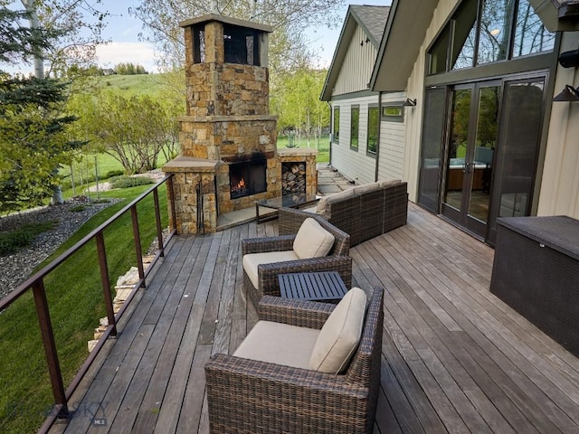 65 Triple Tree Ln, Bozeman, MT 59715 - wooden deck with an outdoor stone fireplace and french doors